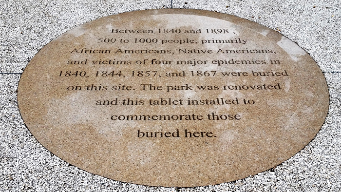 Text on Center Medallion noting the site as a burial ground for African Americans, Native Americans and those affected by plagues.